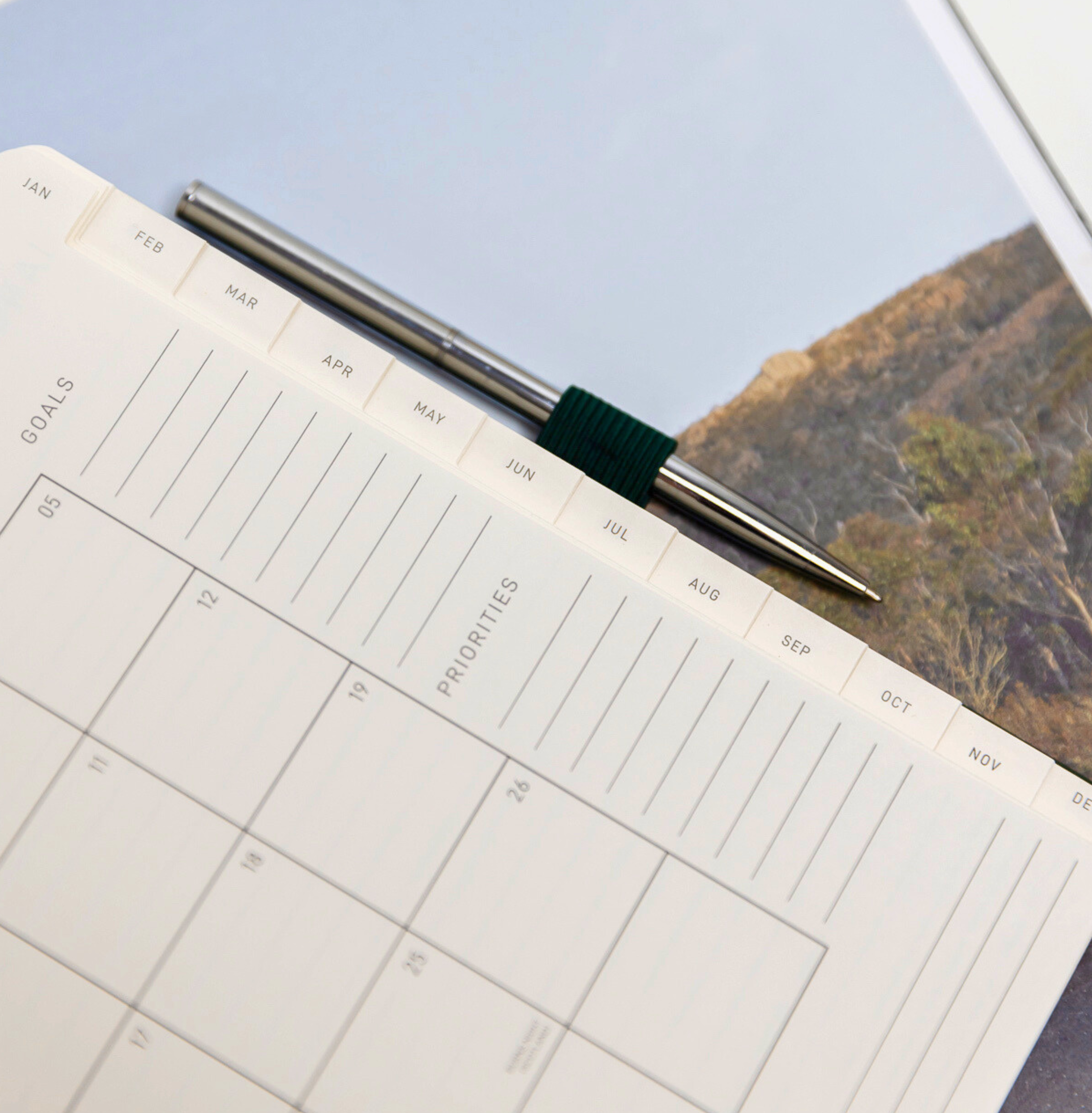 Corner detail of the 2027 A6 Diary | Savanna cover on a sandy flat lay background